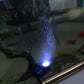 Underwater LED solar spotlight glowing under water with connected panel and cable
