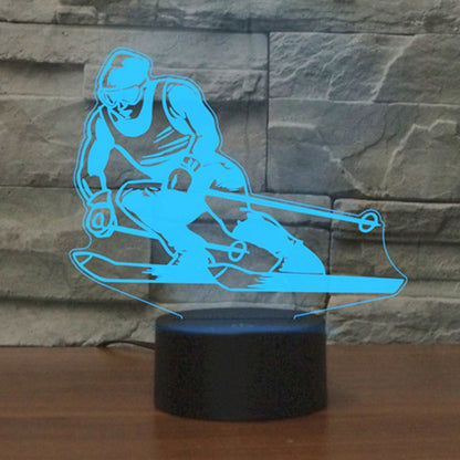 Blue glowing 3D skiing silhouette LED table lamp with round black base