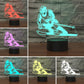 Color-changing skiing silhouette LED table lamp in multicolor light, black base
