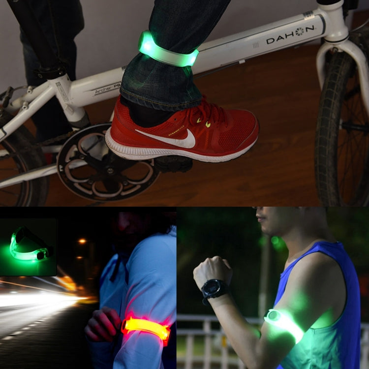 LED light wristband glowing green on red sneaker near bicycle.