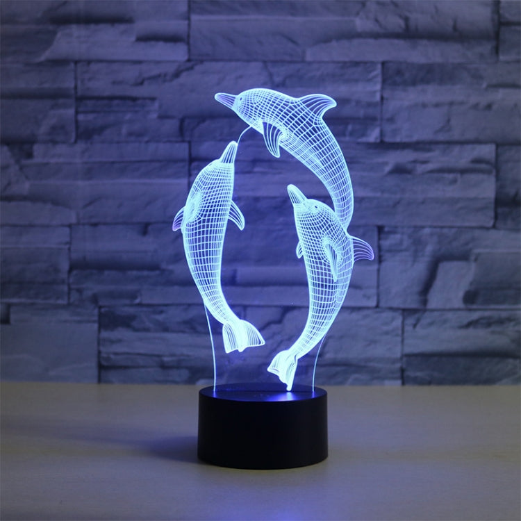 Three-dolphin 3D LED table lamp with blue glowing wireframe dolphins on a black base