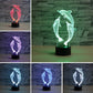 Three-dolphin 3D LED table lamp shown in multiple colors with glowing dolphin wireframe