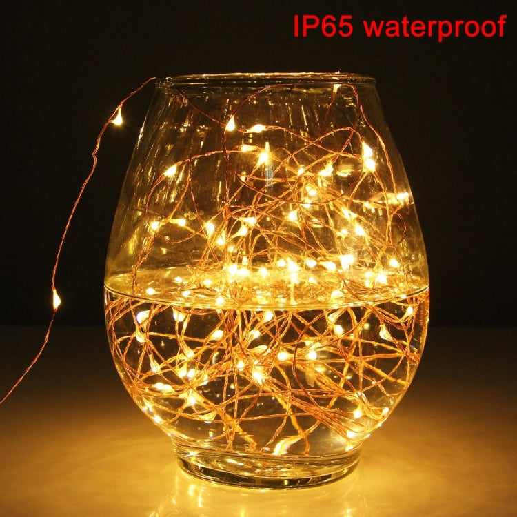 LED fairy string lights glowing in a glass lantern, warm-white style and wire mesh