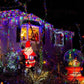 Colorful LED fairy string lights wrapped on outdoor railings and bushes
