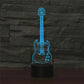 Front view of blue guitar-shaped LED table lamp on a black cylinder base.