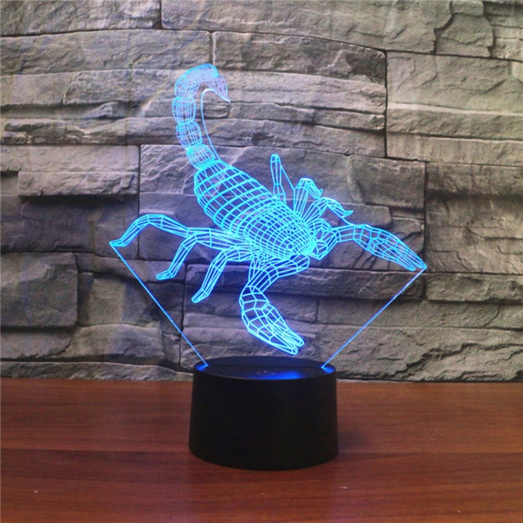 Blue scorpion-shaped LED table lamp with 3D wireframe glow on black base.