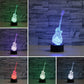 Guitar-shaped LED table lamp showing multicolor light options on black base