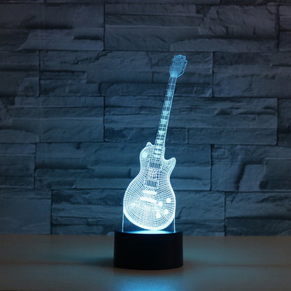 Guitar-shaped LED table lamp with glowing blue light on a black base