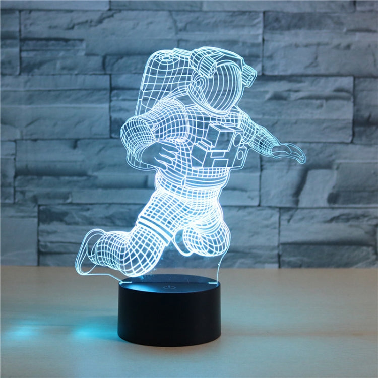 Astronaut 3D LED table lamp with white wireframe astronaut and blue base glow on black stand
