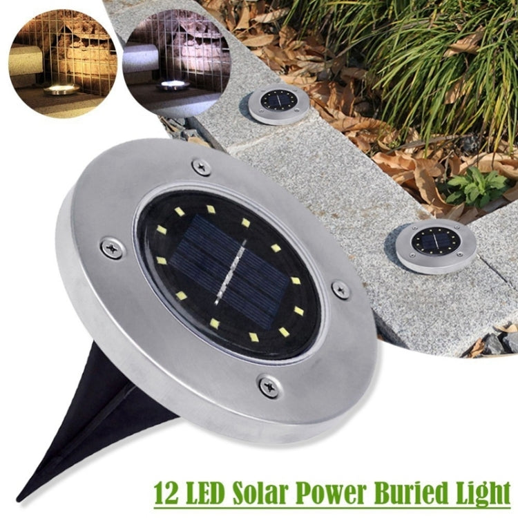 Solar ground LED light on stone path, round lens with visible LED segments