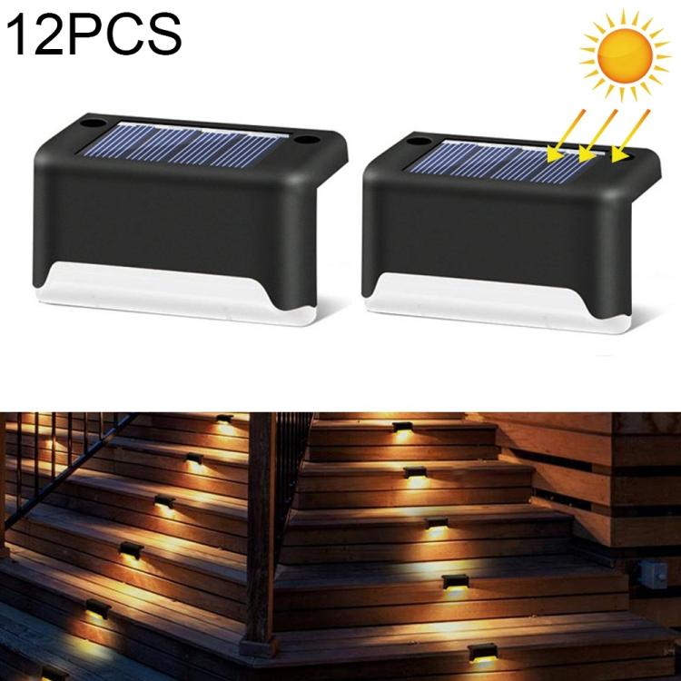 Solar powered outdoor stair lights, black plastic with built-in solar panels and warm glow.