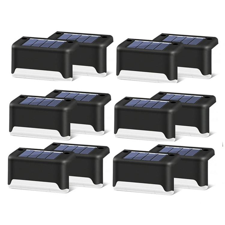 Set of black solar step lights with rectangular solar panels and low-profile lamp housings.