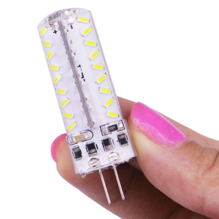 Hand holding clear G4 LED capsule bulb with white LED chips and two pins
