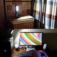 Blue portable work light with bright LED panel and hanging hook on table