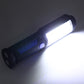 Blue portable work light shining from a compact handheld lantern body