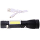 Black USB rechargeable LED torch flashlight with charging cable plugged in