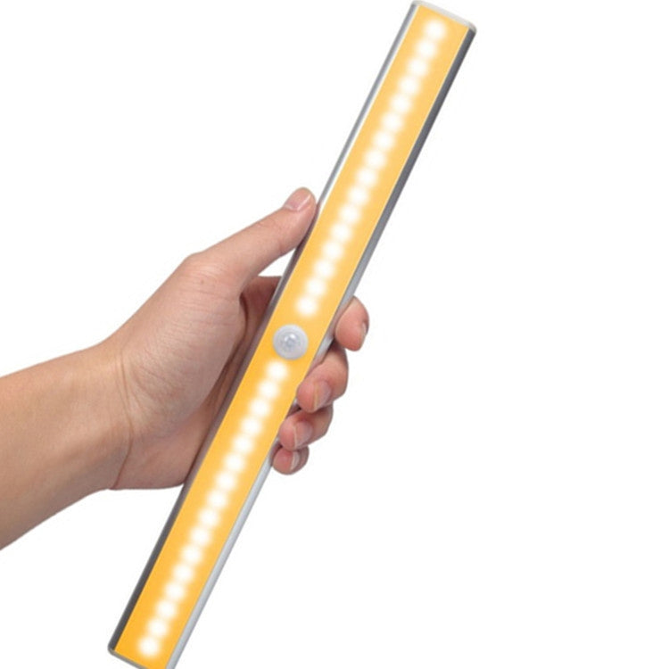 Slim LED light bar with warm white glow and round PIR sensor near the end