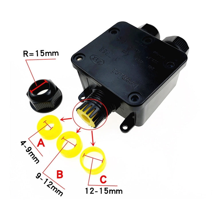 Black junction box with yellow cable gland and mounting holes