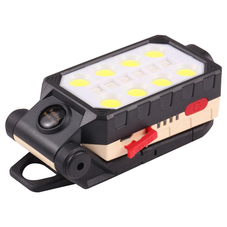 Folding LED work light with side handle, beige panel, red switch, and round dial