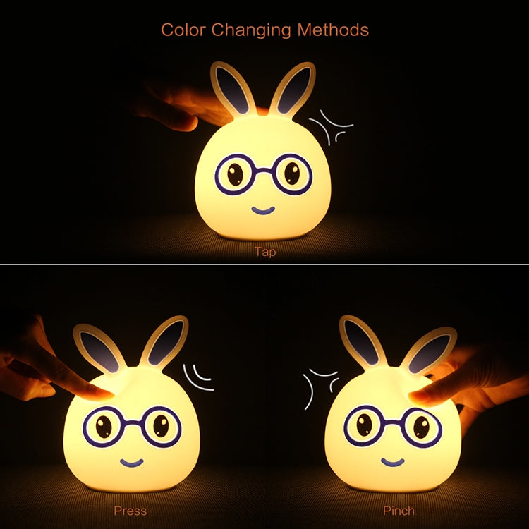 Color-changing LED rabbit night light glowing yellow, smiling face and glasses
