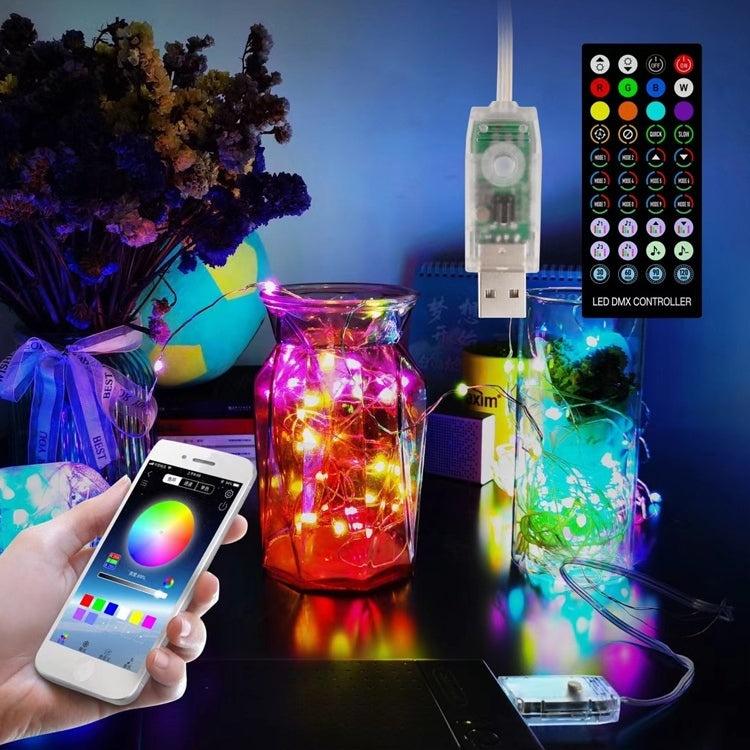 USB LED controller hanging above multicolor copper wire string lights with glowing bulbs