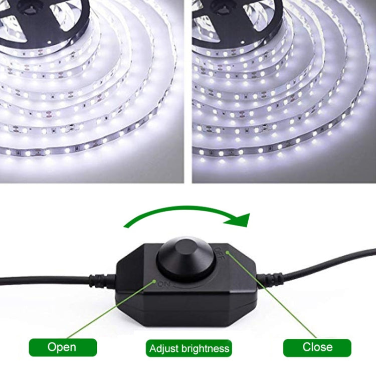 Black LED dimmer controller with round knob, connected cable, and brightness arrows
