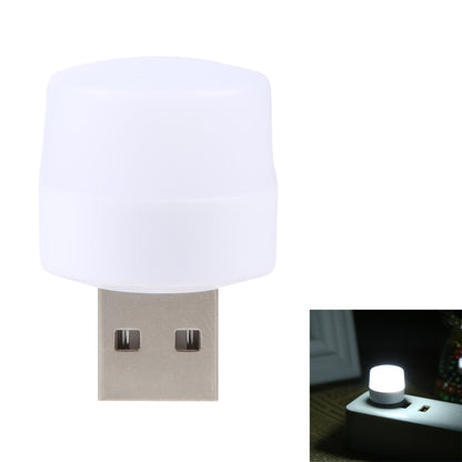 Round LED USB mini night light with white glowing cap on a silver USB plug