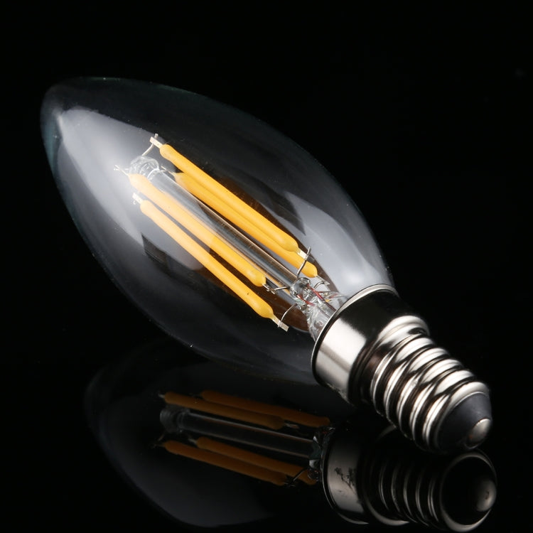 Retro LED filament bulb with E14 screw base, glowing yellow filament inside clear glass