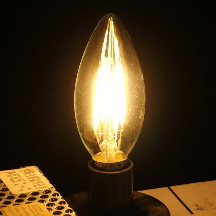 Glowing retro LED filament bulb with clear glass and E14 screw base