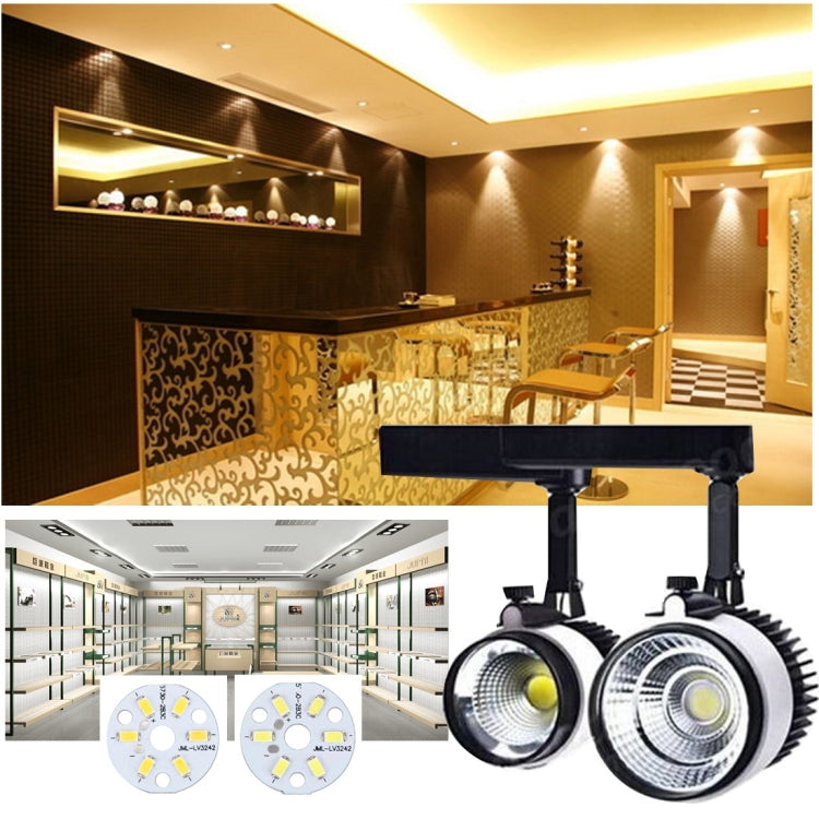Track-style spotlight heads with LED lamps and small circular LED module boards shown
