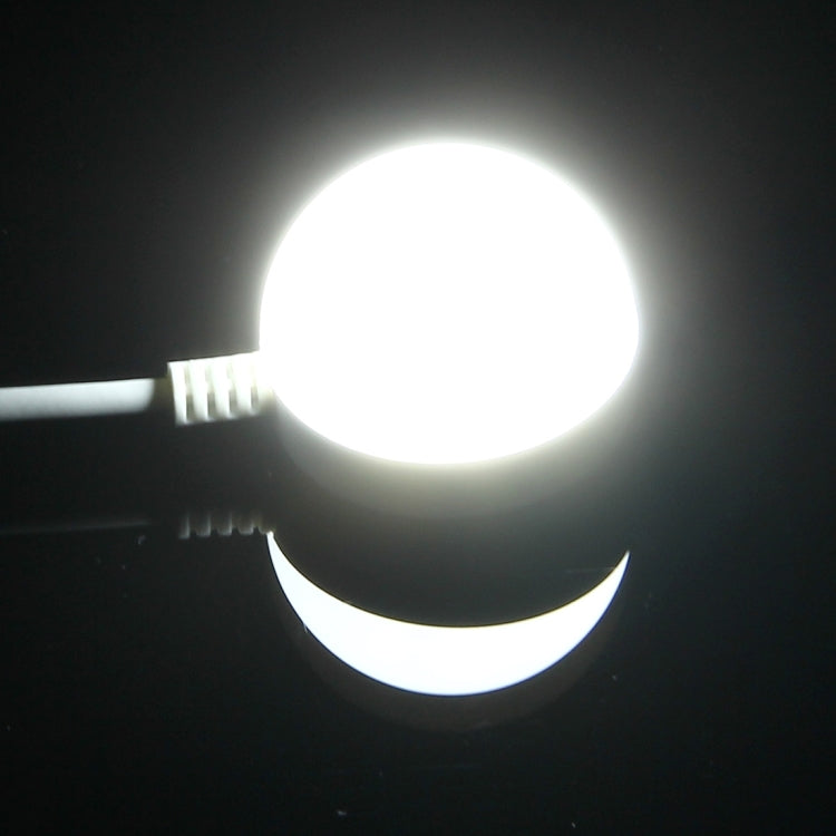 LED puck light emitting bright white light with attached cable