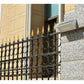 Wall-mounted solar motion sensor light in silver on outdoor building wall