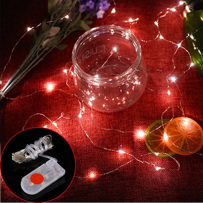 Red LED fairy string lights with button battery pack and wire coil, waterproof design