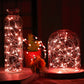 Warm red LED fairy lights in glass bottles and dome jar, glowing wire strands