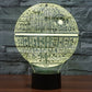 Yellow glowing Death Star style dome desk lamp with circuit pattern on black base