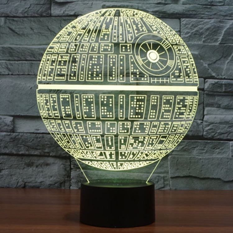 Yellow glowing Death Star style dome desk lamp with circuit pattern on black base