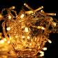 Warm amber glowing LED icicle-style string lights with clear plastic light bars
