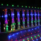 Lit LED reticular string lights hanging in rows with multicolor bulbs