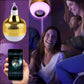 Gold LED music light bulb glowing in purple with hanging loop