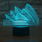 Sydney Opera House style desk lamp with blue LED line art, on black base