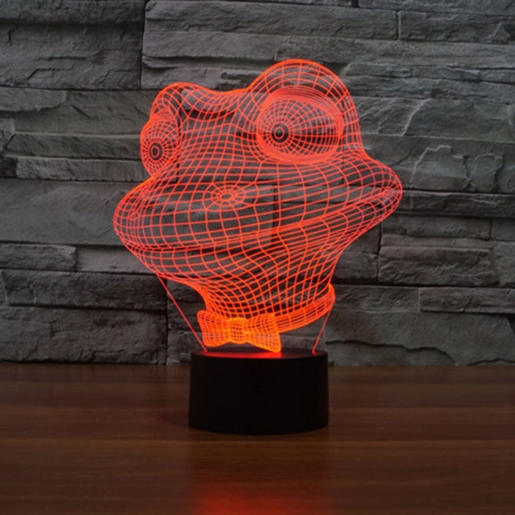 Orange wireframe frog night light on black base, glowing