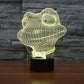Yellow wireframe frog night light on black base, glowing