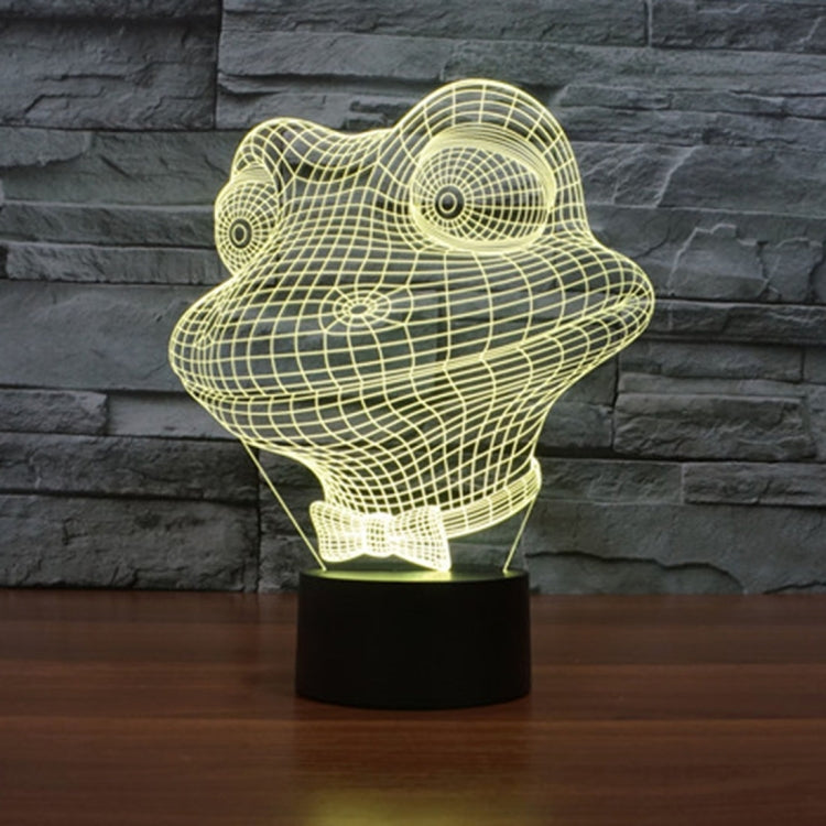 Yellow wireframe frog night light on black base, glowing