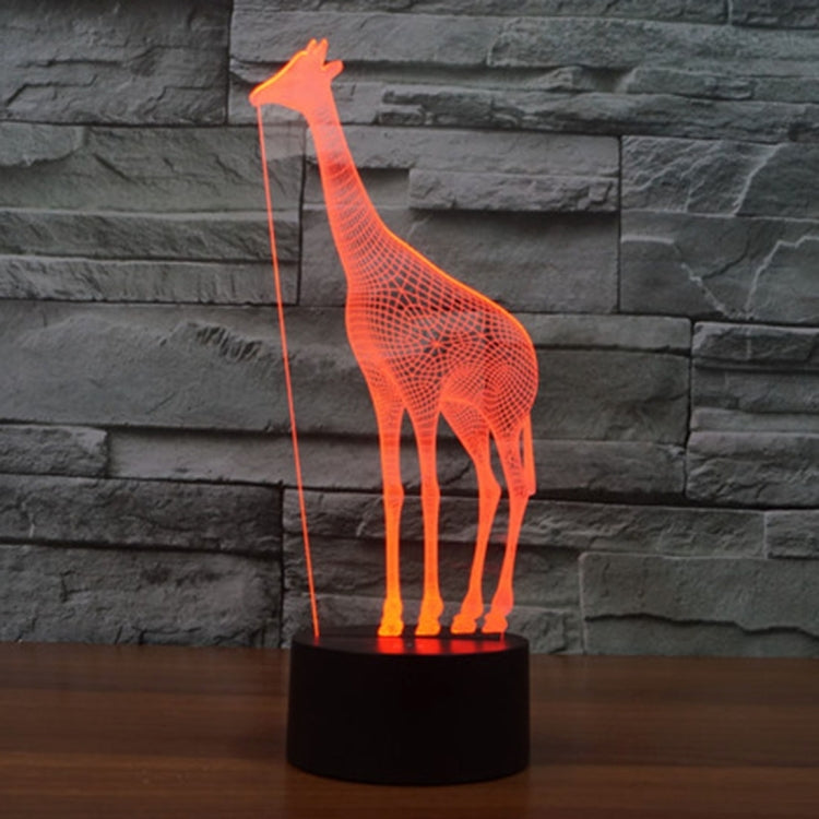 Orange glowing giraffe desk night light with black cylindrical base