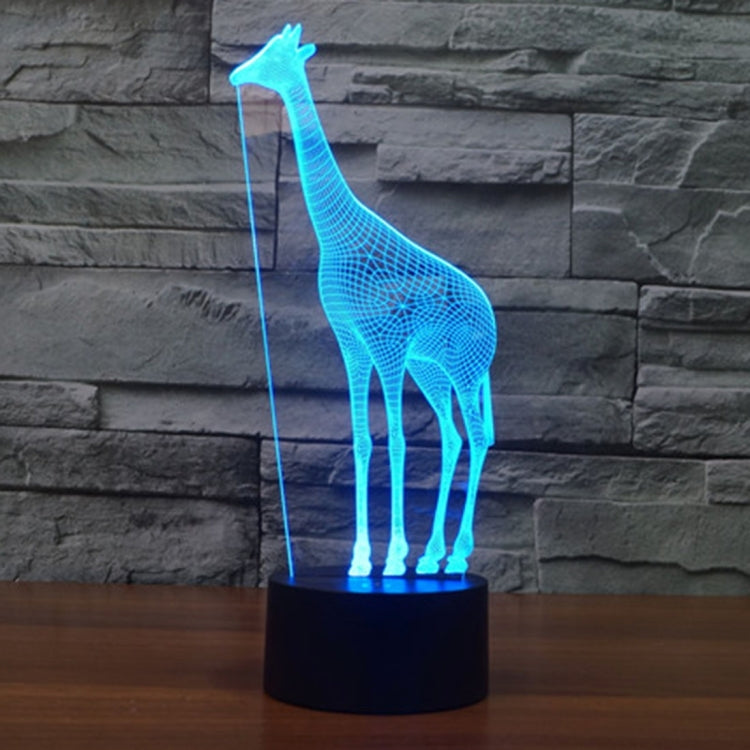 Blue glowing giraffe desk night light with black cylindrical base