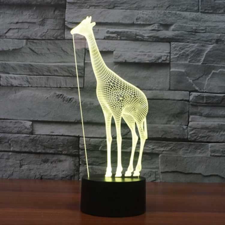 Yellow glowing giraffe desk night light with black cylindrical base