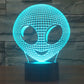 Alien face LED desk lamp with grid dome, cyan glow, rounded eyes and smile, on base