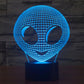 Alien-style desk lamp with glowing blue wireframe alien head and dark base