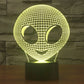 Alien-style desk lamp with glowing yellow wireframe alien head and dark base