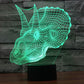 Green dinosaur-shaped LED desk lamp with wireframe glow on stand